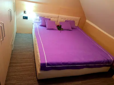 a large purple bed with purple pillows in a room at Apartment Superior Centar in Kopaonik