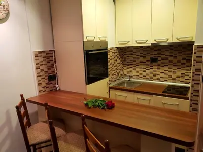 a kitchen with a wooden counter top and a sink at Apartment Superior Centar in Kopaonik