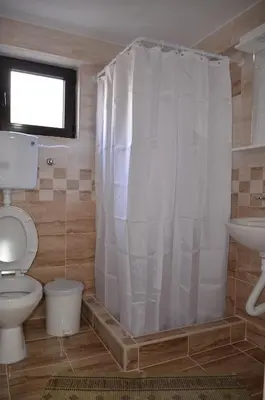 a bathroom with a toilet and a sink at Apartmani Janja in Soko Banja