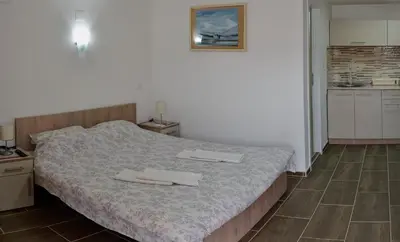 a bedroom with a bed with two towels on it at Apartmani Janja in Soko Banja