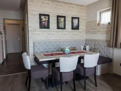a dining room with a table and chairs at Fabulous Luxury Apartment G7 in Kopaonik