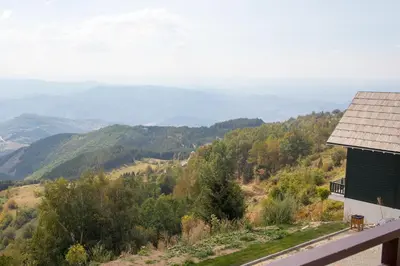 a house on a hill with a view of the mountains at Fabulous Luxury Apartment G7 in Kopaonik
