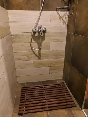 a shower with a shower head in a bathroom at Fabulous Luxury Apartment G7 in Kopaonik