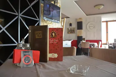 a table with books and glasses on top of it at Fabulous Luxury Apartment G7 in Kopaonik