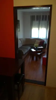 a living room with a couch and a mirror at Felix Apartment in Soko Banja