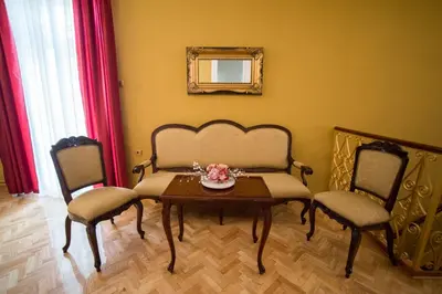 a dining room with a table and two chairs at Center Deluxe Garni Hotel in Niš