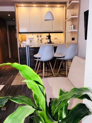 a kitchen with a table and chairs and a plant at Tim 135 Konaci-Angella Centar in Kopaonik