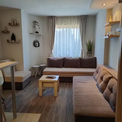 a living room with a couch and a table at Tim 135 Konaci-Angella Centar in Kopaonik