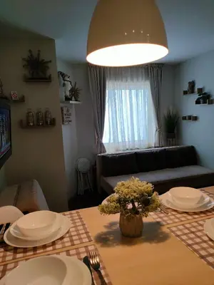 a living room with a table and a couch at Tim 135 Konaci-Angella Centar in Kopaonik