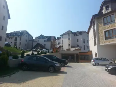 a group of cars parked in a parking lot at Lux apartment Milmari Reko E4 Kopaonik in Kopaonik