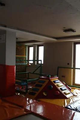 a childrens play area with a slide in a room at Lux apartment Milmari Reko E4 Kopaonik in Kopaonik