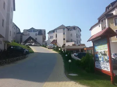 a street with some buildings and a sign on the side at Lux apartment Milmari Reko E4 Kopaonik in Kopaonik
