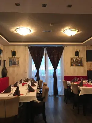 a restaurant with tables and chairs in a room at Lux apartment Milmari Reko E4 Kopaonik in Kopaonik
