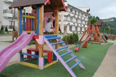 a playground with a slide and a play structure at Lux apartment Milmari Reko E4 Kopaonik in Kopaonik