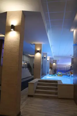 a building with a swimming pool and a staircase at Lux Apartment Milmari Reko Premier 14 Kopaonik in Kopaonik