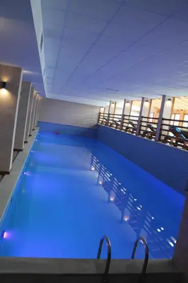 a large swimming pool with blue lighting in a building at Lux Apartment Milmari Reko Premier 14 Kopaonik in Kopaonik