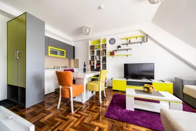 a living room with a kitchen and a dining room at Apartman Biblioteka Čardaka 10/61 in Kopaonik