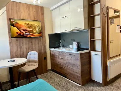 a small kitchen with a sink and a table at Select Lux Angella-Konaci in Kopaonik
