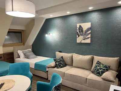 a living room with a couch and a bed at Select Lux Angella-Konaci in Kopaonik