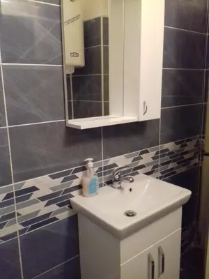 a bathroom with a sink and a mirror at City Center Apartment JOTIC in Pirot