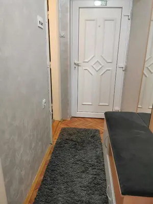 a room with a door and a rug in front of a door at City Center Apartment JOTIC in Pirot