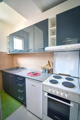 a kitchen with a white stove top oven at City Center Apartment JOTIC in Pirot