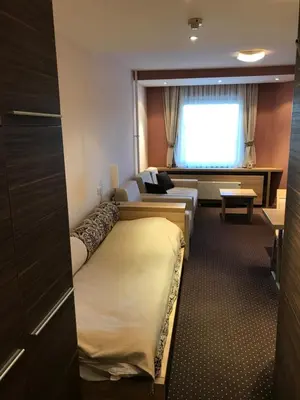 a hotel room with a bed and a couch at Apartman Konaci Maglic in Kopaonik