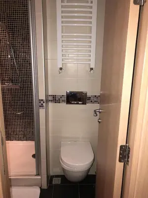a small bathroom with a toilet and a shower at Apartman Viktor in Kopaonik