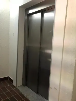 a elevator in a building with a metal door at Apartman Viktor in Kopaonik