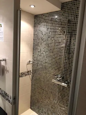 a bathroom with a shower with a glass door at Apartman Viktor in Kopaonik