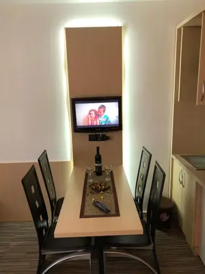 a room with a table and chairs with a television at Apartman Viktor in Kopaonik