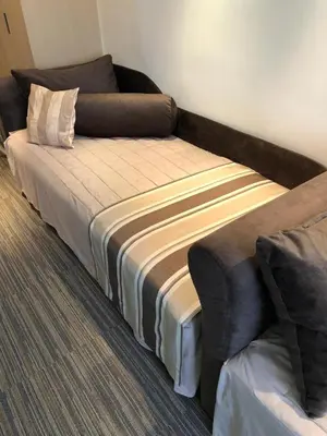 a bed and a couch in a room at Apartman Viktor in Kopaonik