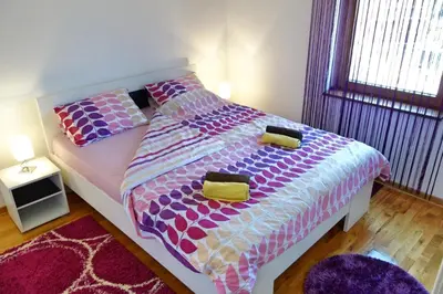 a bedroom with a bed with two pillows on it at Stella Apartments in Vrnjačka Banja