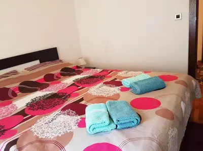 a bedroom with a bed with two towels on it at Stella Apartments in Vrnjačka Banja