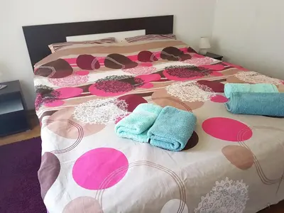 a bed with hats and towels on top of it at Stella Apartments in Vrnjačka Banja