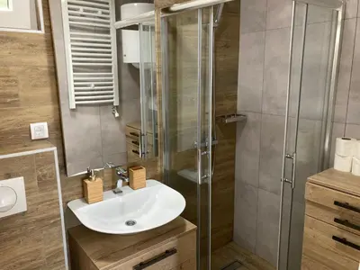 a bathroom with a sink and a shower at Family Apartmani Kopaonik in Kopaonik