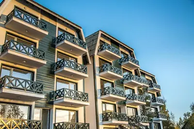 an apartment building with balconies on the side of it at Family Apartmani Kopaonik in Kopaonik