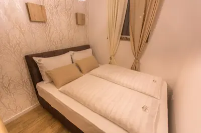 a small couch with pillows on it in a room at Family Apartmani Kopaonik in Kopaonik