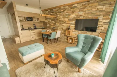 a living room with a couch chair and a table at Family Apartmani Kopaonik in Kopaonik