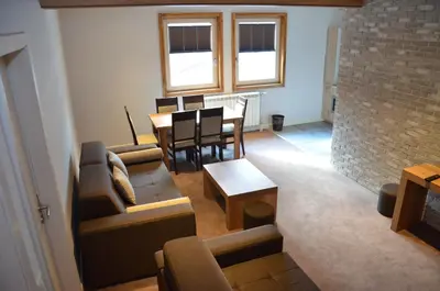 a living room with a couch and a table at Župa Apartmani in Kopaonik
