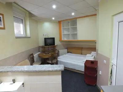 a small room with a bed and a television at Apartment 102, Vila 