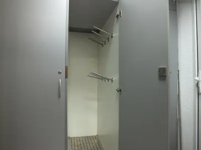 a hallway with white doors and a tile floor at Apartment 102, Vila 
