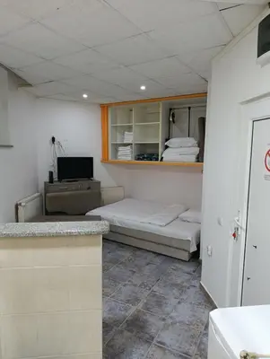 a room with two beds and a desk at Apartment 102, Vila 