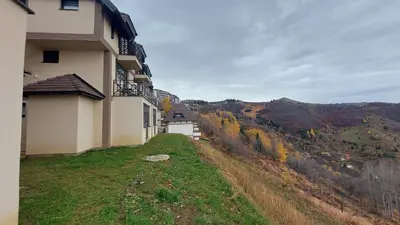 a building on top of a hill with a view at Apartments Topview Kopaonik-Dvori in Kopaonik