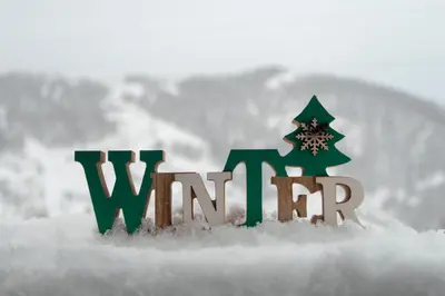 a christmas sign in the snow with a christmas tree at Apartments Topview Kopaonik-Dvori in Kopaonik
