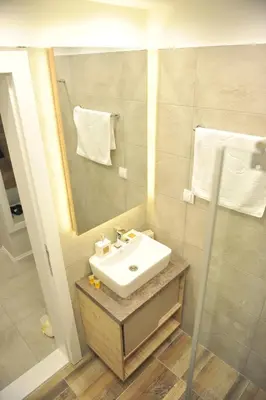 a bathroom with a sink and a mirror at Milmari Resort Premier 47 in Kopaonik
