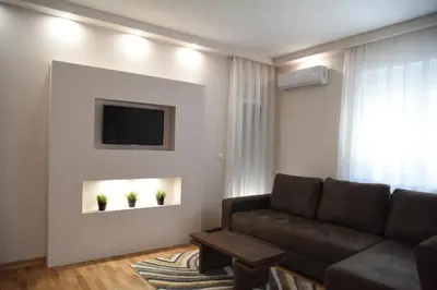 a living room with a couch and a tv at Vrnjacka Idila in Vrnjačka Banja
