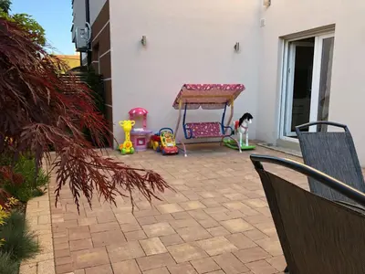 a patio with a table and childrens toys at Vrnjacka Idila in Vrnjačka Banja