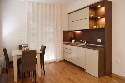 a kitchen and dining room with a table and a sink at Vrnjacka Idila in Vrnjačka Banja
