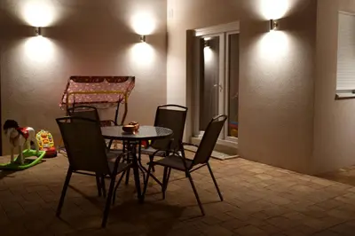 a dining room with a table and chairs and a crib at Vrnjacka Idila in Vrnjačka Banja